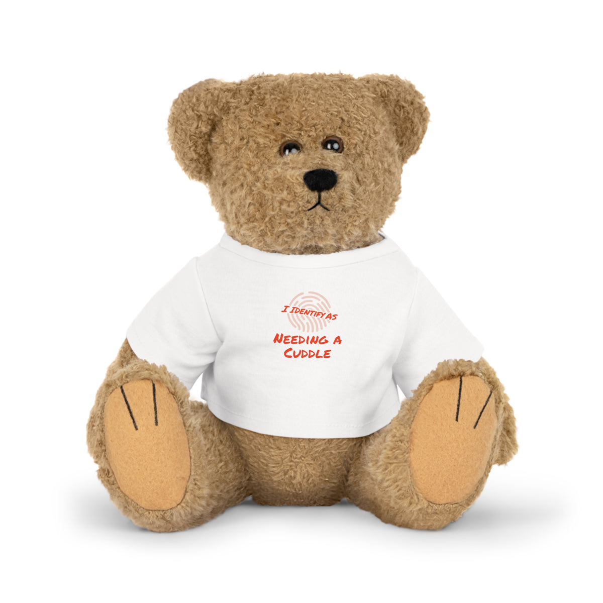 Teddy bear wearing a white shirt with a pink cross on a white background