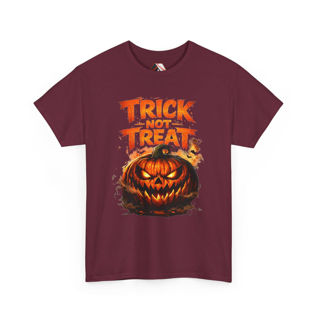 A maroon short-sleeve crewneck t-shirt featuring a Halloween graphic print with the text 'TRICK NOT TREAT' above a glowing jack-o'-lantern pumpkin, shown on a plain white background.