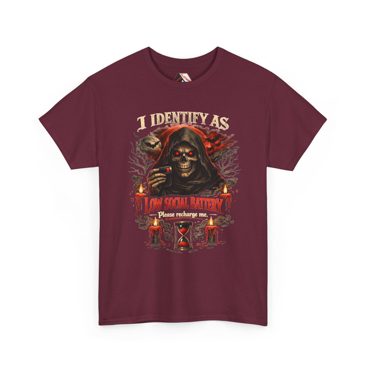 A maroon short-sleeve crewneck t-shirt featuring a graphic print of a grim reaper with glowing red eyes and the text 'I IDENTIFY AS A LOW SOCIAL BATTERY Please recharge me.' on the front, displayed against a solid white background.