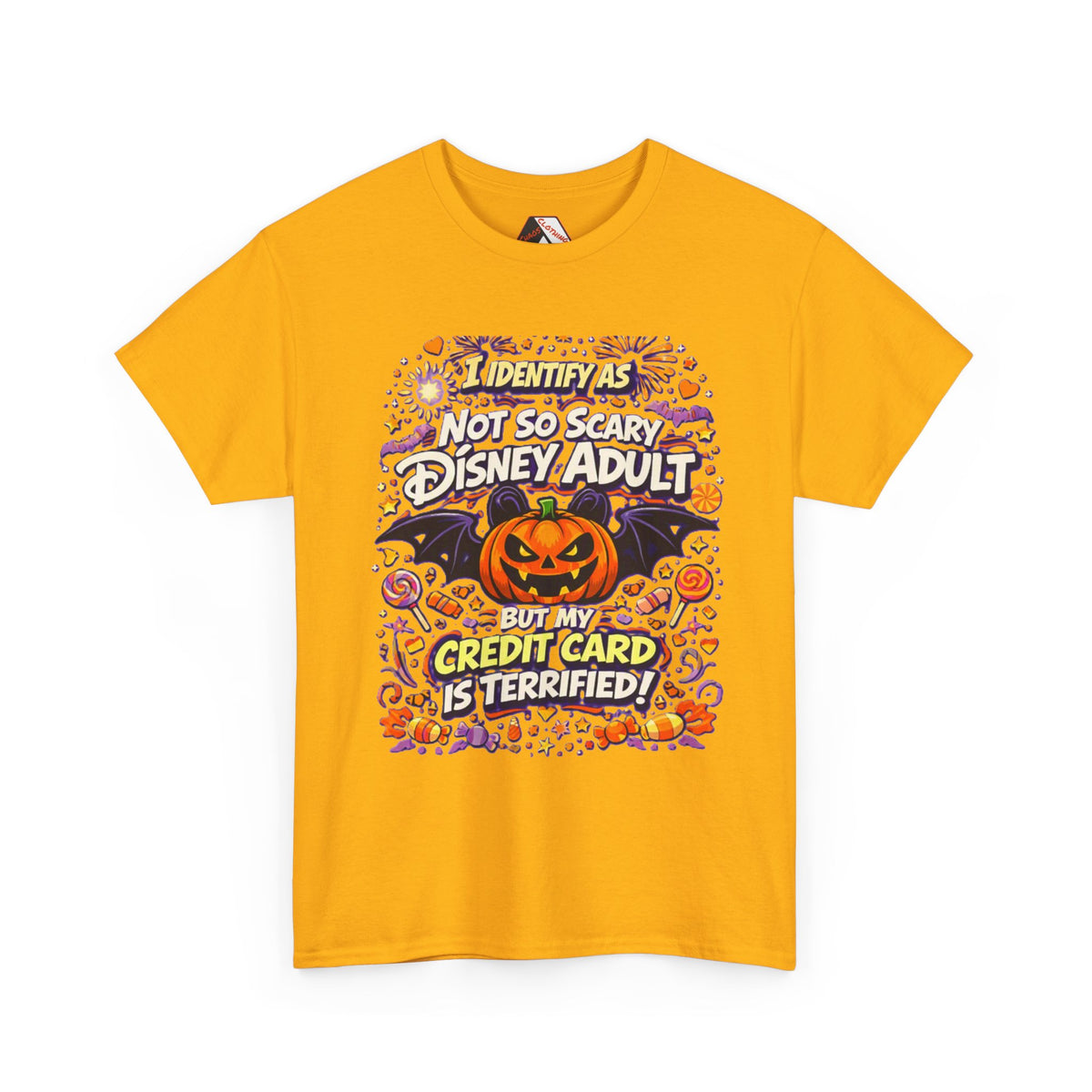 A yellow short-sleeve crewneck t-shirt with a colorful graphic print on the front. The graphic features a jack-o'-lantern, bats, candy corn, and fireworks, with the text 'I IDENTIFY AS NOT SO SCARY DISNEY ADULT BUT MY CREDIT CARD IS TERRIFIED!' in stylized fonts.
