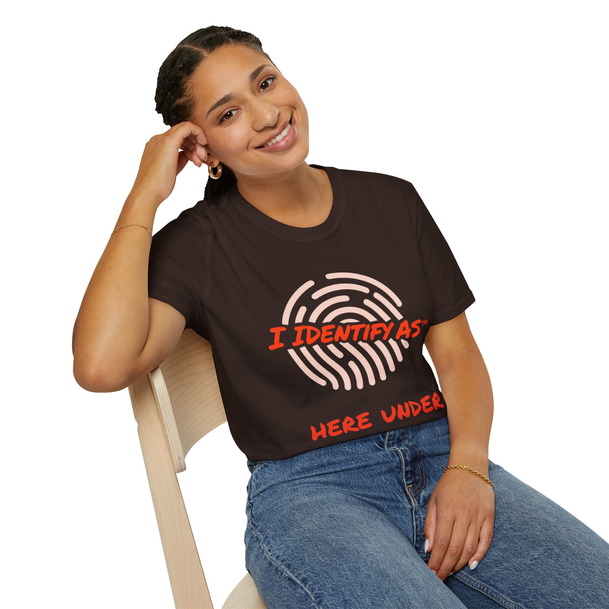 Person wearing a dark gray t-shirt with a graphic design sitting on a chair.