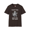 Brown T‑shirt featuring cartoon character Chaos Carl with the slogan “Lean Into The Chaos”  by I Identify As