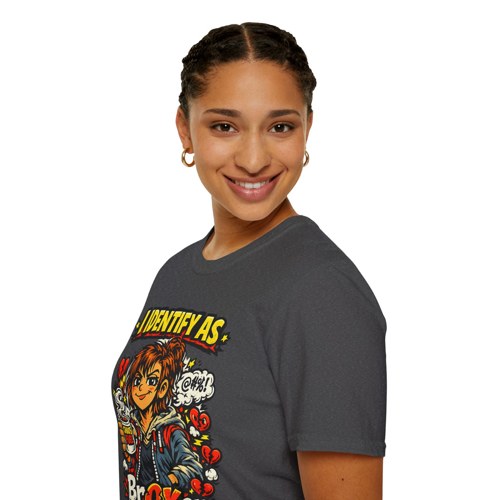 A woman wearing a dark gray graphic t-shirt with a comic-style illustration of Chucky and the text 'IDENTIFY AS'. The photo is taken against a solid white background from Chaos Clothing by I Identify As
