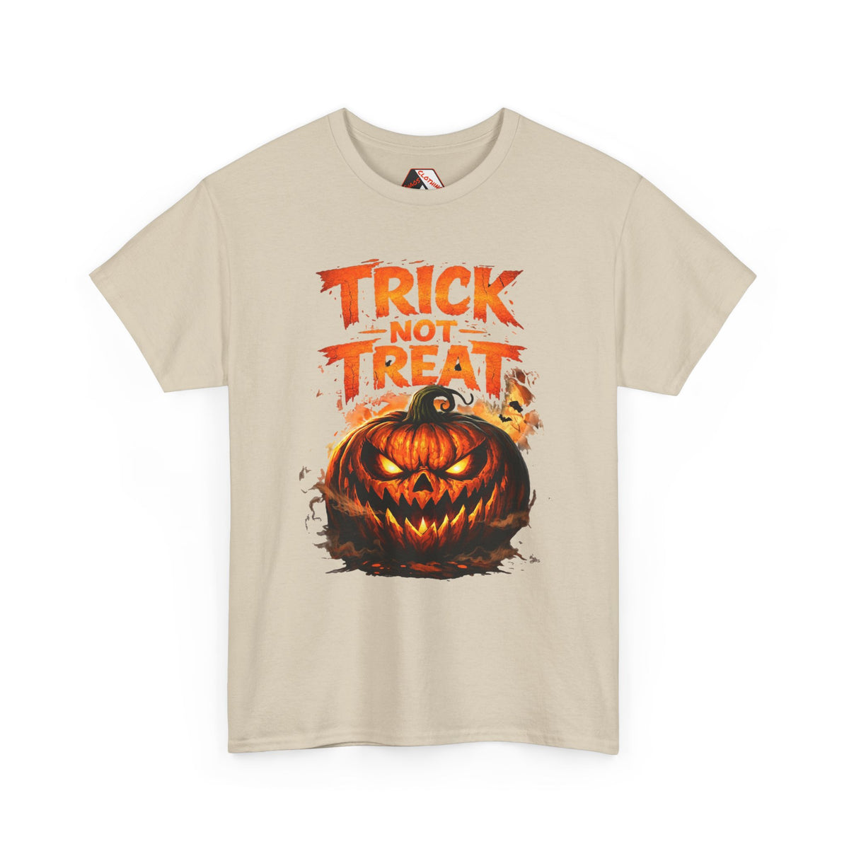 A light beige crewneck t-shirt featuring a Halloween graphic print with the text 'TRICK OR TREAT' in orange above a carved jack-o'-lantern pumpkin.