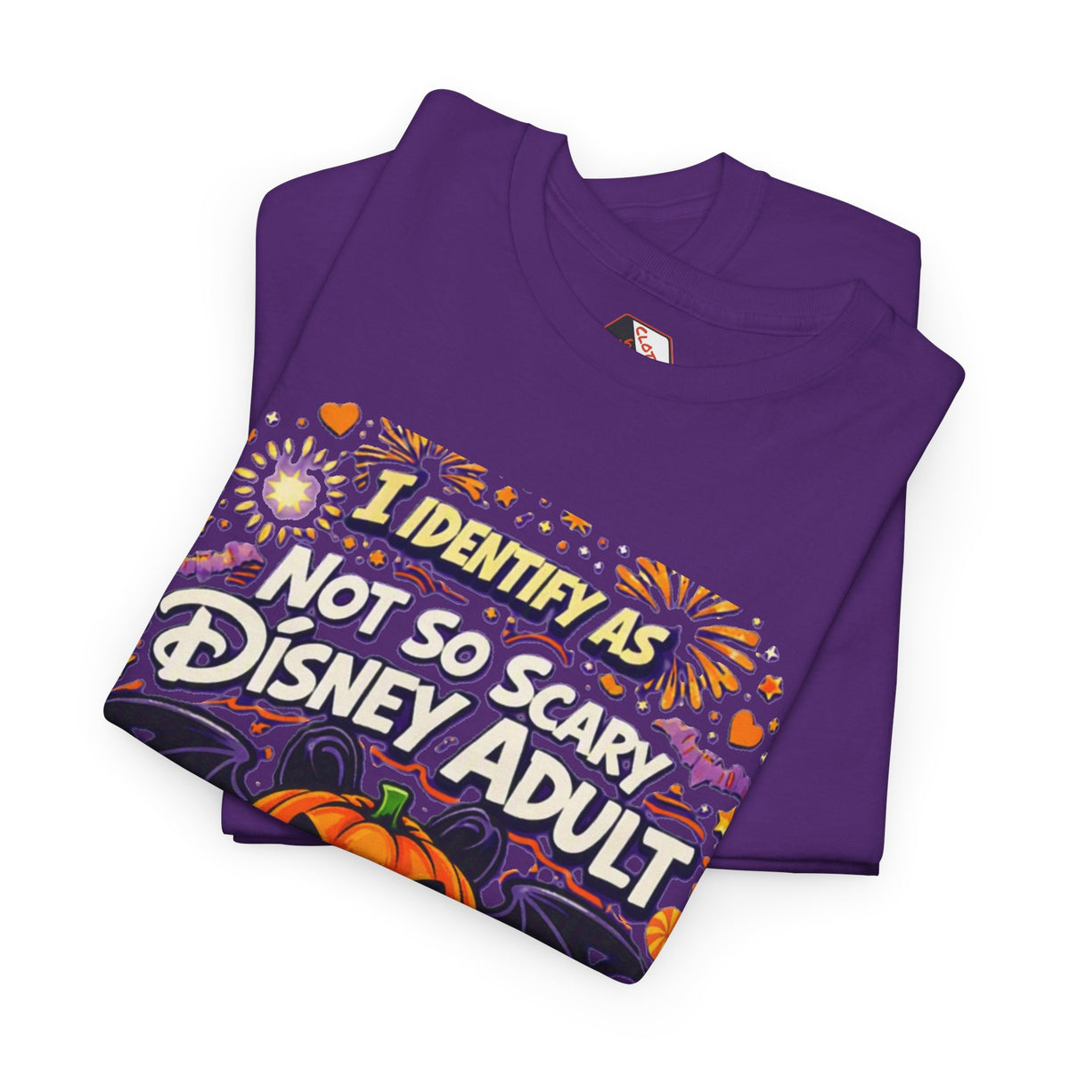 A Purple folder short-sleeve crewneck t-shirt with a colorful graphic print on the front. The graphic features a jack-o'-lantern, bats, candy corn, and fireworks, with the text 'I IDENTIFY AS NOT SO SCARY DISNEY ADULT