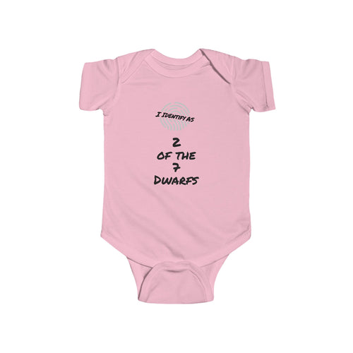A light pink baby bodysuit with short sleeves and snap closures, featuring a black and gray graphic print on the chest that reads 'I IDENTIFY AS 2 OF THE 7 DWARFS' with a small coin graphic above.