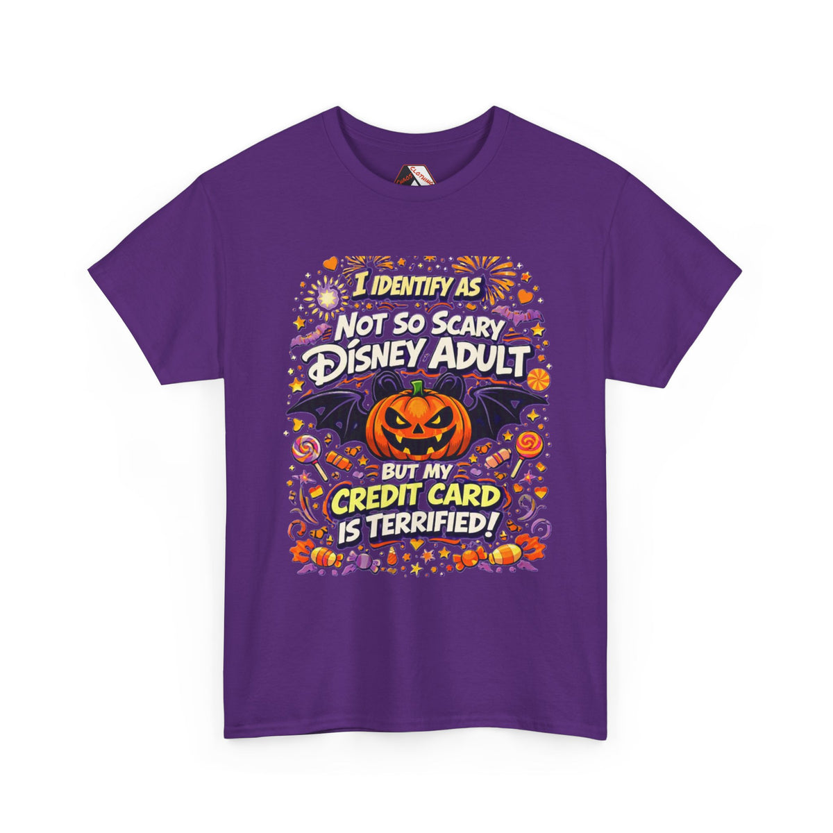 A purple short-sleeve crewneck t-shirt with a colorful graphic print on the front. The graphic features a jack-o'-lantern, bats, candy, and text that reads 'I identify as Not so Scary Disney Adult but my Credit Card is Terrified!'.